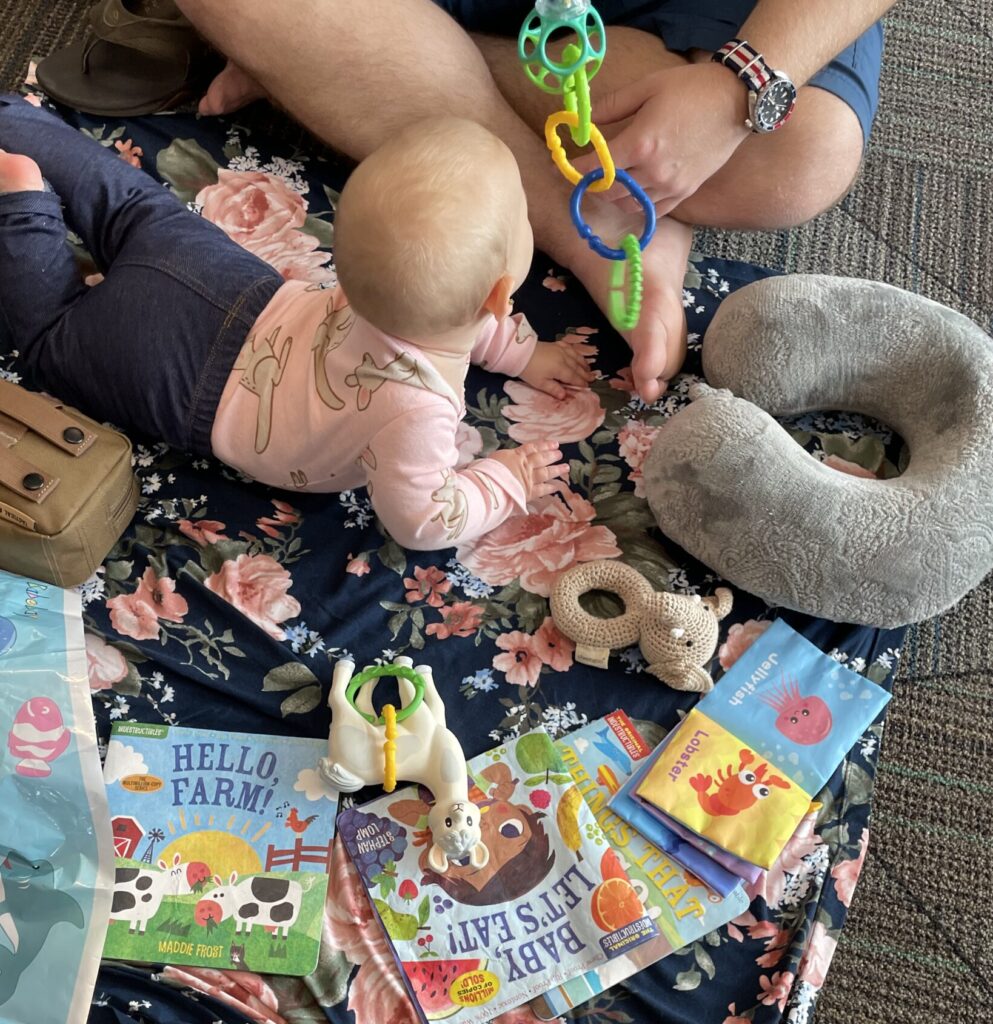 Baby playing on a blanket on the floor